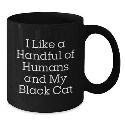 Funny Black Cat Lover Gifts from Friends for Graduation - 'I Like A Handful Of Humans And My Black Cat' Black Coffee Mug, 11oz or 15oz - Victory Thru Vision